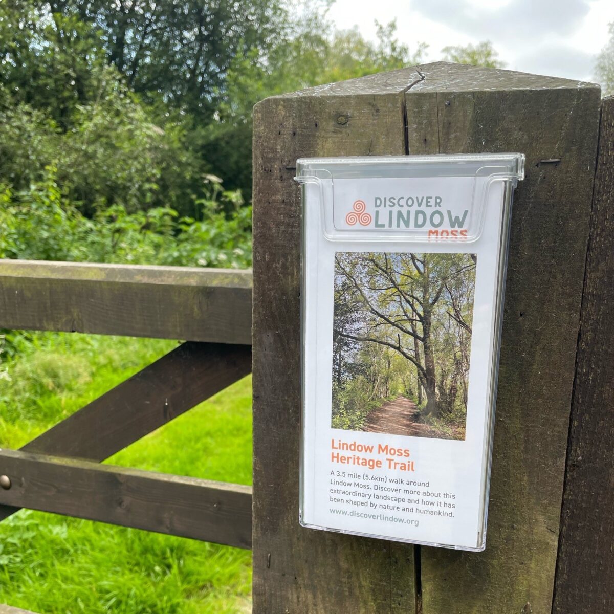 Outdoor leaflet holder shown in use at Lindow Moss Trail